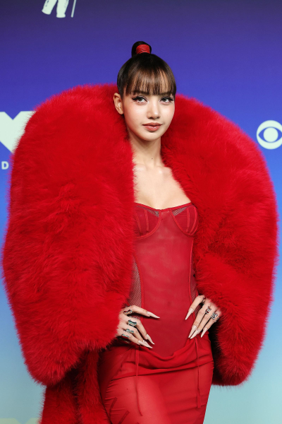 Lisa poses in a red dress and red fur coat